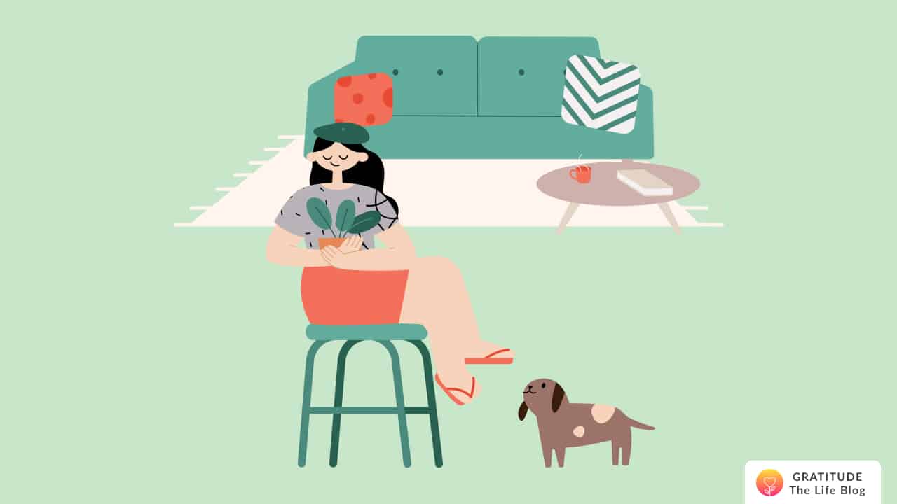 This is an image of a woman holding her plant, next to her dog, in her simple home