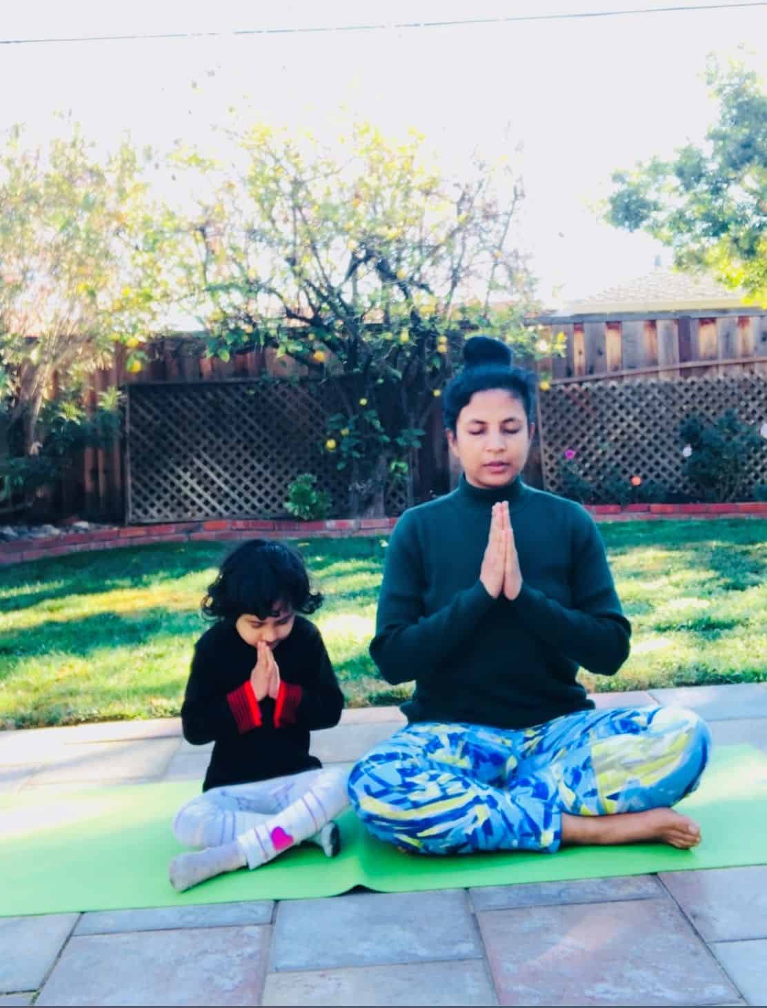 This is a photo of Keerti doing pranayama with her daughter, Milli