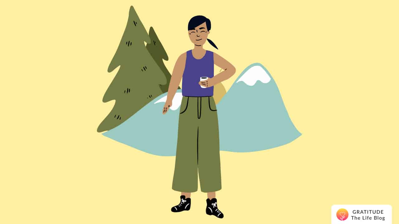 This is an image of a woman with mountains and trees behind her