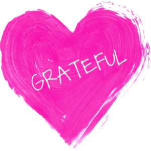 A pink heart with the word "GRATEFUL" written on it