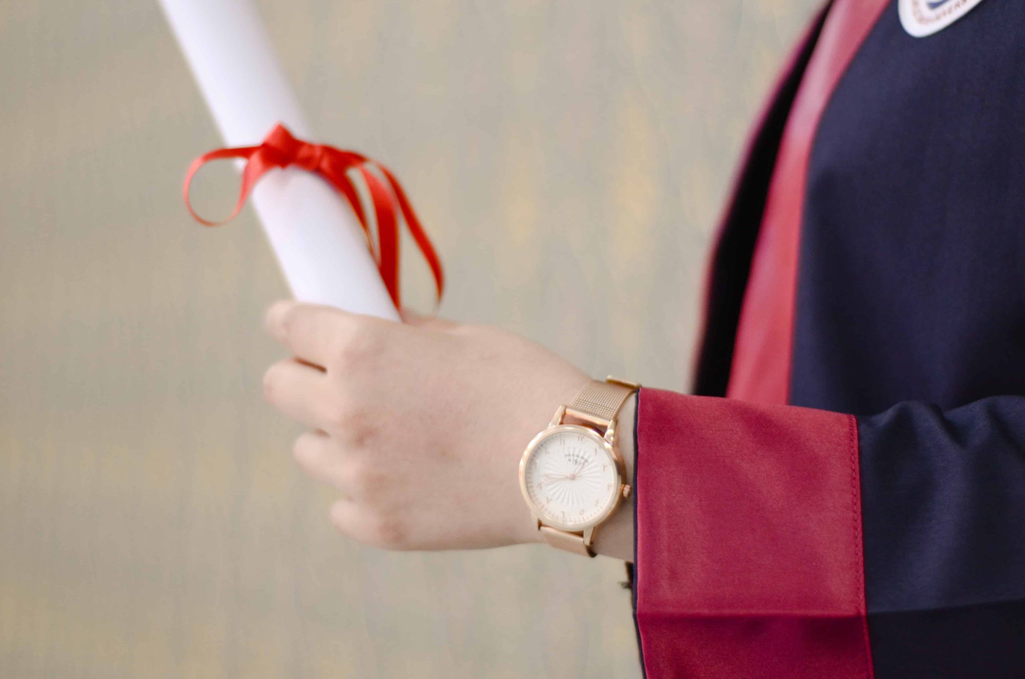 Photo of a hand holding graduation letter