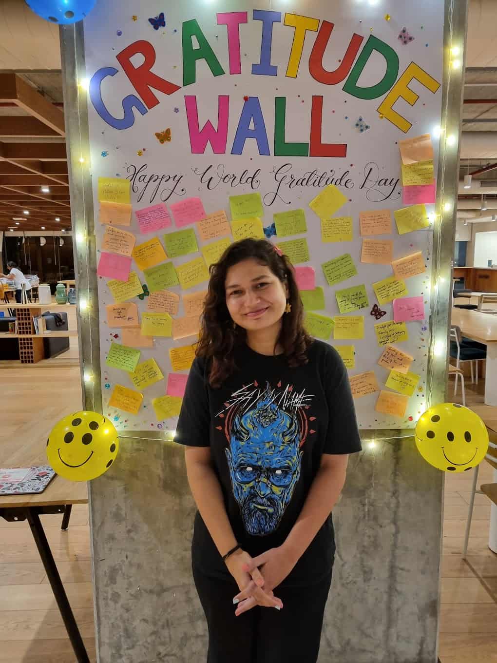 Photo of Aarushi in front of the Gratitude Wall